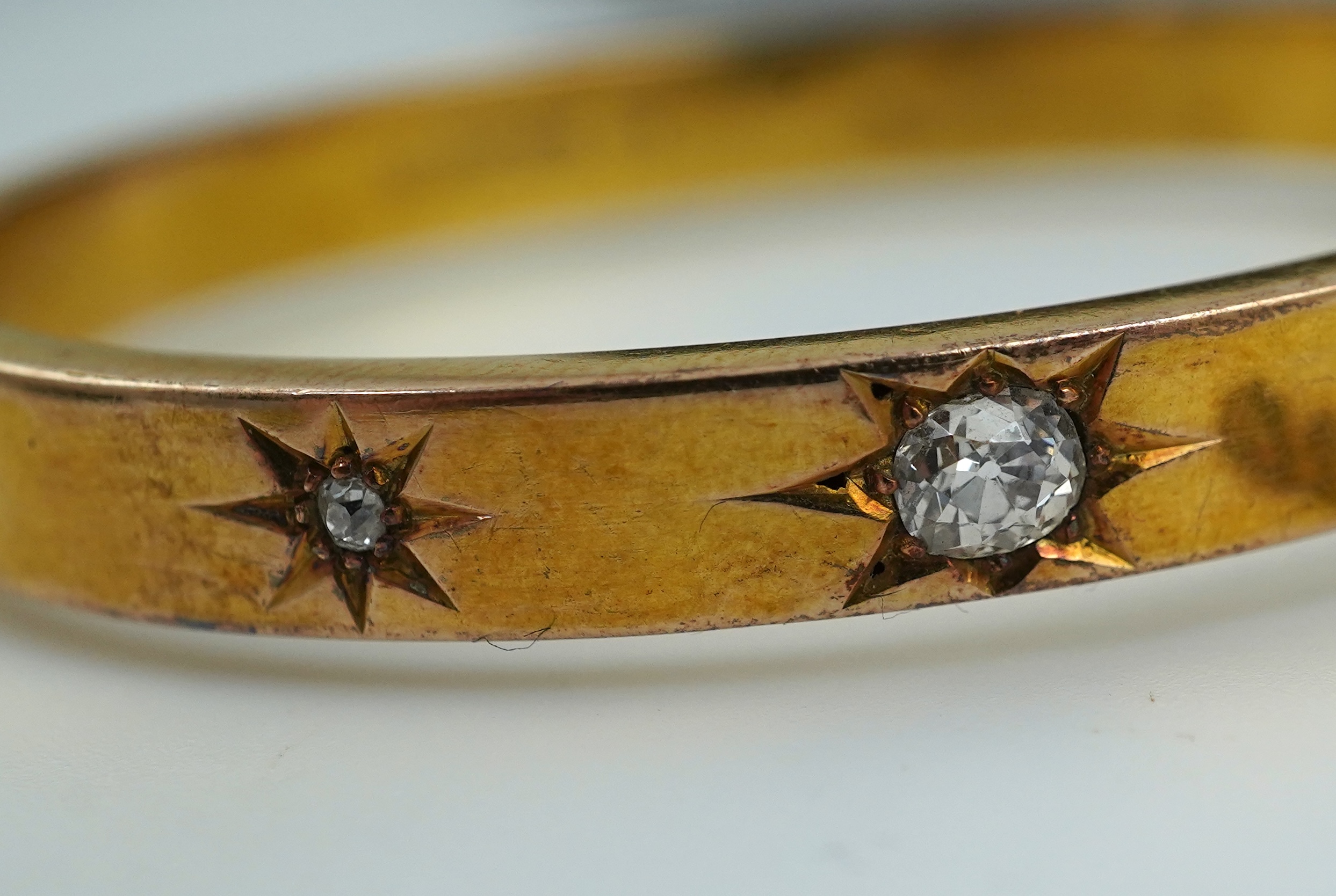 An Edwardian 15ct gold and diamond bangle, circa 1904